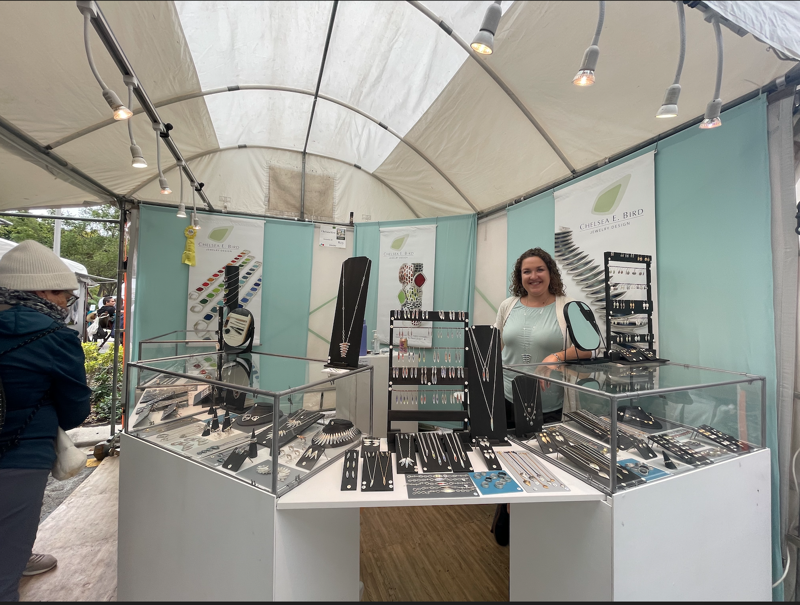 Bird's jewelry stand at the Coconut Grove Art Festival displayed hand-made sterling silver and glass enamel jewelry. 